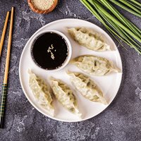 Top down photo of Chinese dim sim with a side of soy sauce