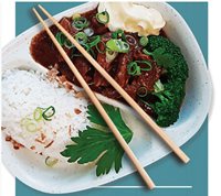 Top down photo of a Japanese beef dish served with a side of rice