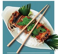 Top down photo of a Japanese teriyaki chicken dish served with a side of rice